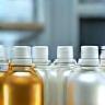 Rows of custom-branded cosmetic bottles in a lab