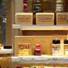 Arrangement of handmade soaps and cosmetic jars displayed on shelves